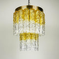 Chandelier with gold and clear glass design on a neutral background